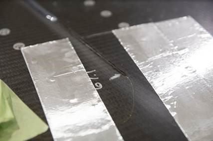 Image of fiber sensors on composite skin of wing spar of Boom supersonic jet